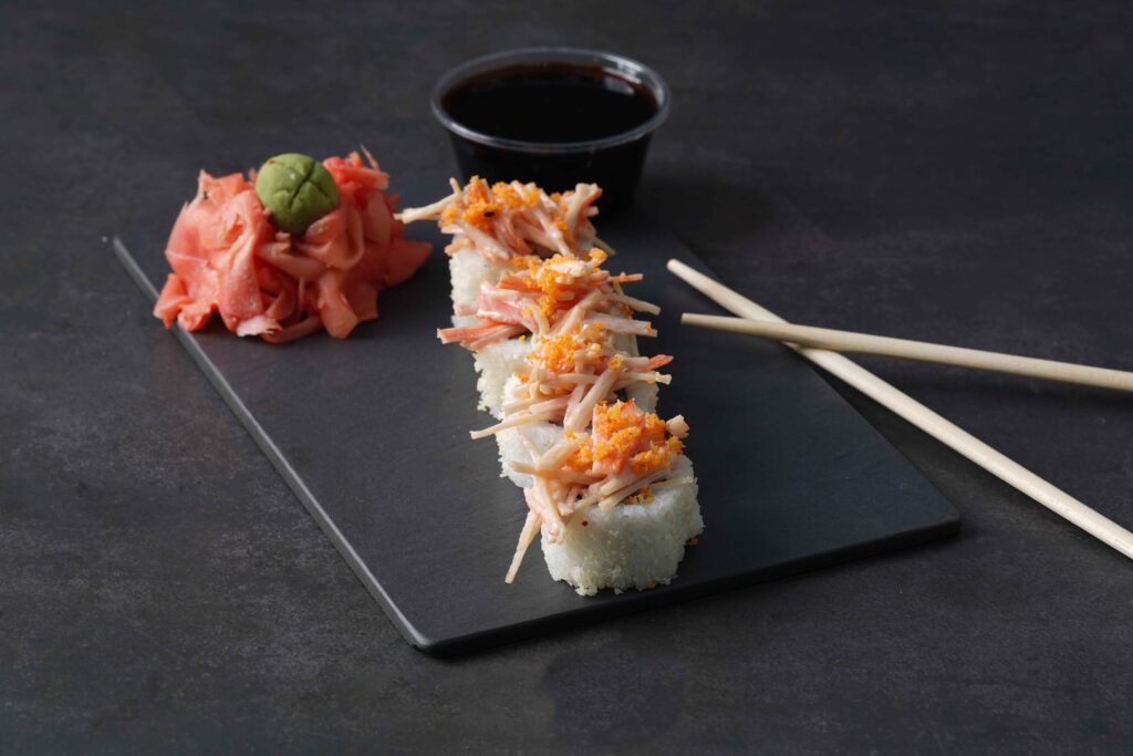 crazy California sushi with sauce and chopsticks