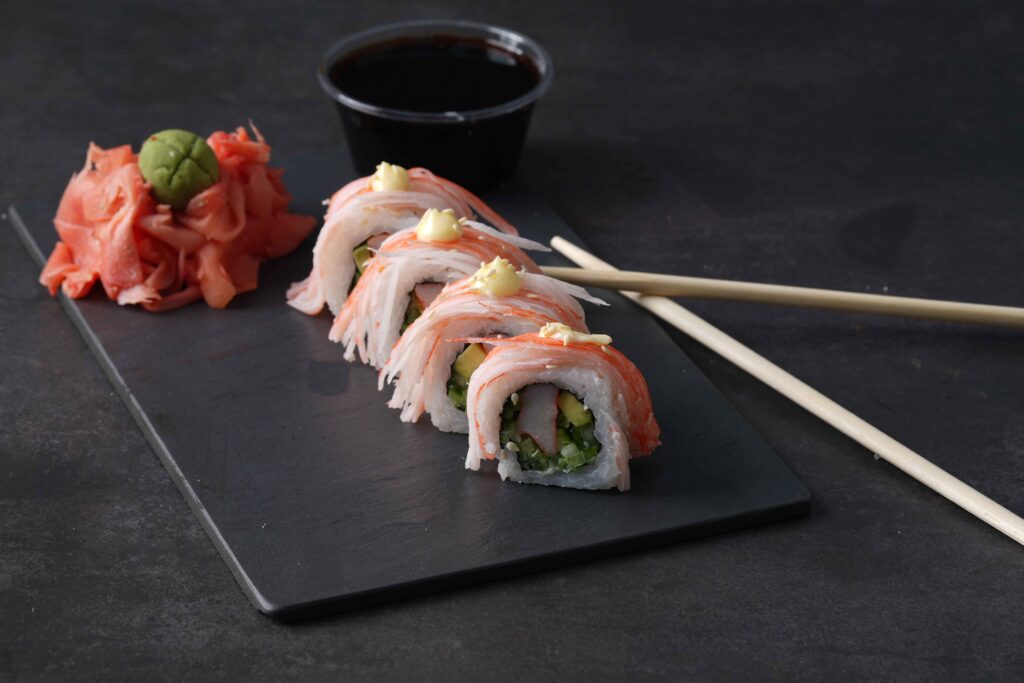 sushi with sauce and chop sticks