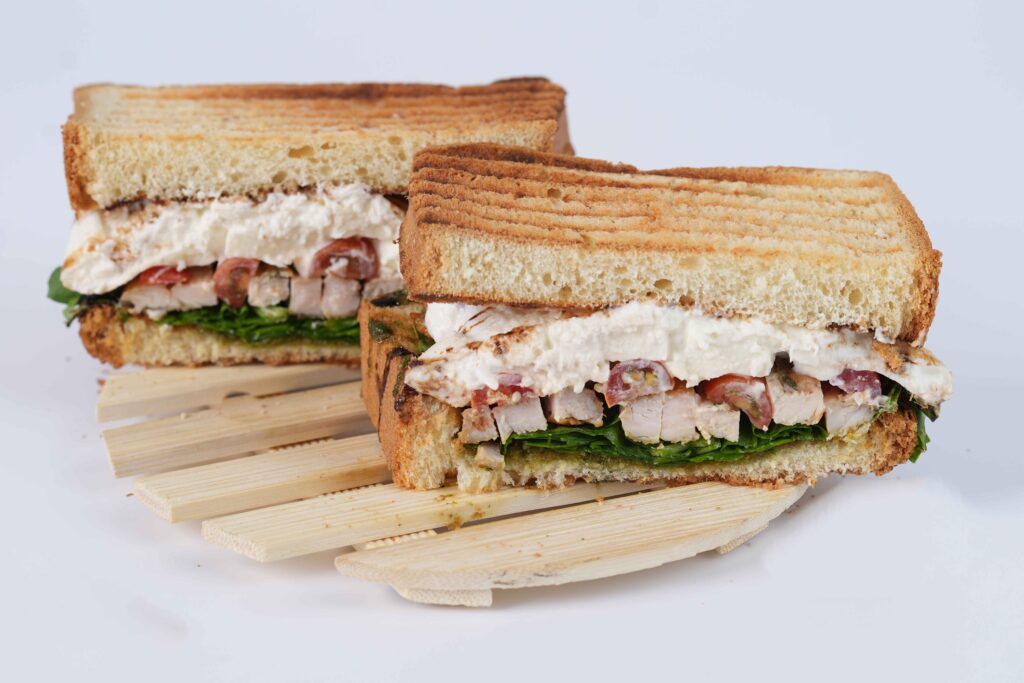 image of a healthy sandwich from a healthy restaurant in Riyadh. the sanwich name is The-Chicken-Caprese-Sandwich