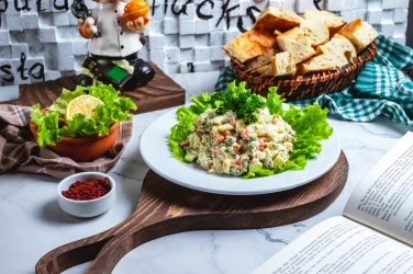 side-view-capital-salad-lettuce-with-bread-slice-lemon-table