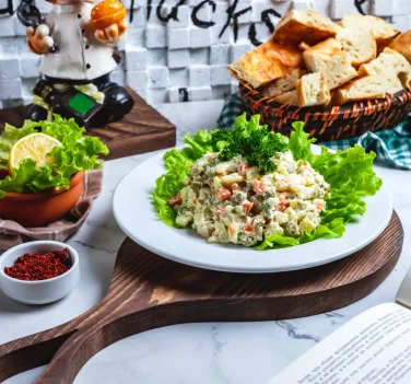 side-view-capital-salad-lettuce-with-bread-slice-lemon-table